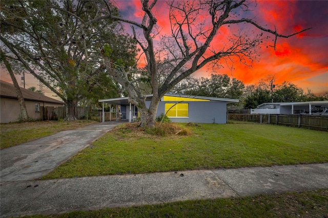 view of front of house with a lawn and a carport