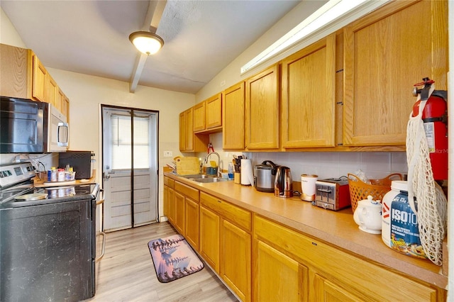 kitchen with backsplash, light hardwood / wood-style floors, beam ceiling, sink, and range with electric stovetop