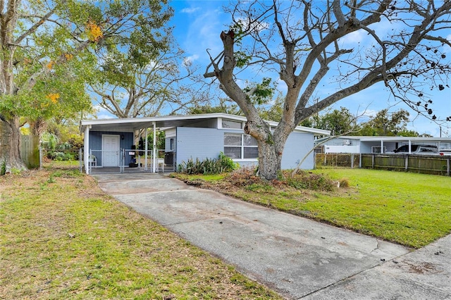 view of front of home with a front lawn and a carport