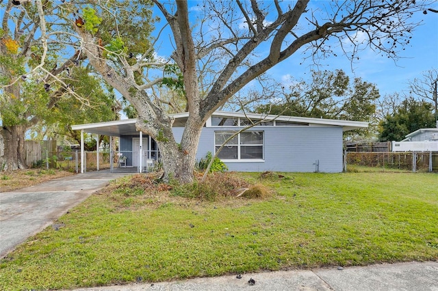 view of front facade with a front lawn and a carport