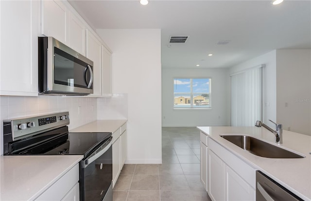 6805 SW 90th Loop, Ocala, FL 34476 - kitchen with tasteful backsplash, visible vents, appliances with stainless steel finishes, white cabinets, and a sink