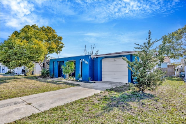 single story home with a front yard and a garage