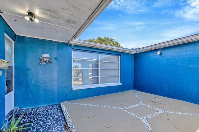 property entrance with a patio