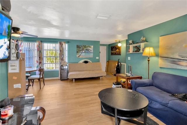 living room with ceiling fan and light wood-type flooring