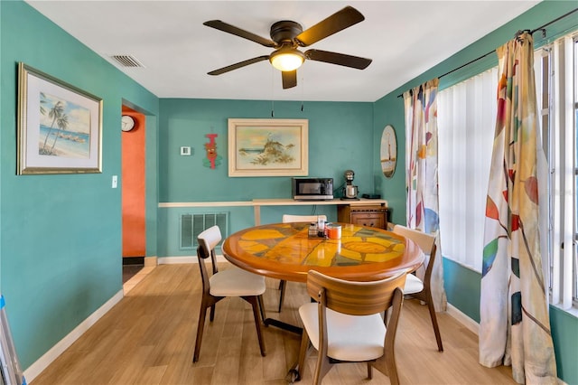 dining area featuring light hardwood / wood-style floors and ceiling fan