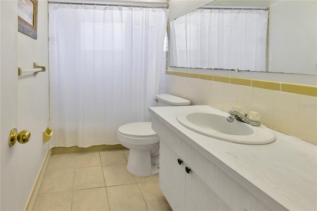 bathroom featuring toilet, tile patterned floors, walk in shower, and vanity