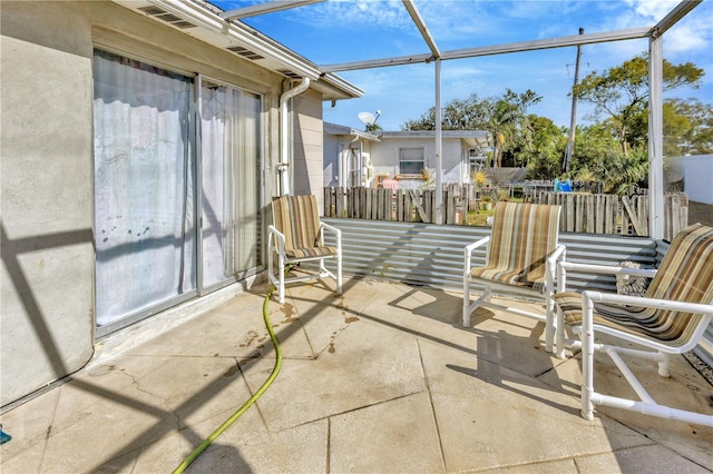 view of patio featuring a lanai