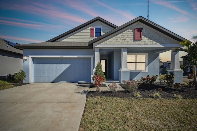 view of front of property featuring a yard and a garage