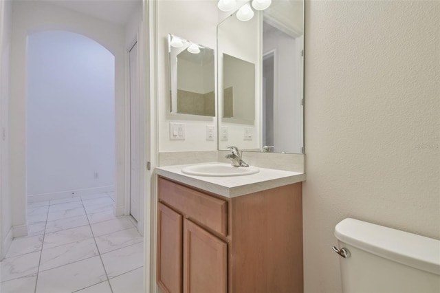 bathroom featuring vanity and toilet