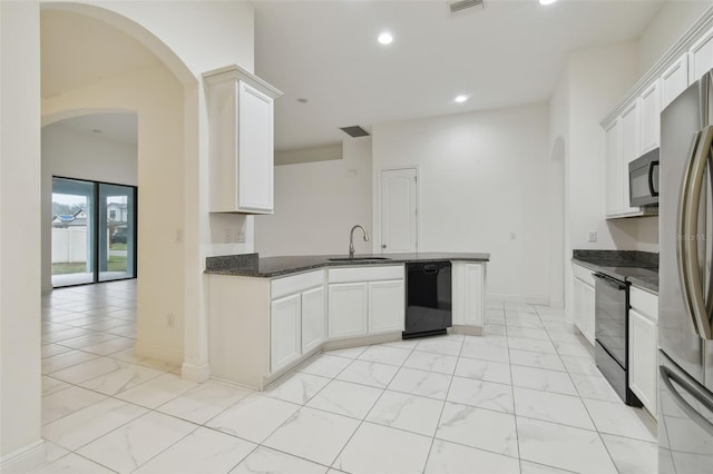 kitchen with black appliances, white cabinetry, sink, dark stone counters, and kitchen peninsula