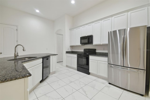 kitchen featuring white cabinetry, dark stone counters, sink, and black appliances