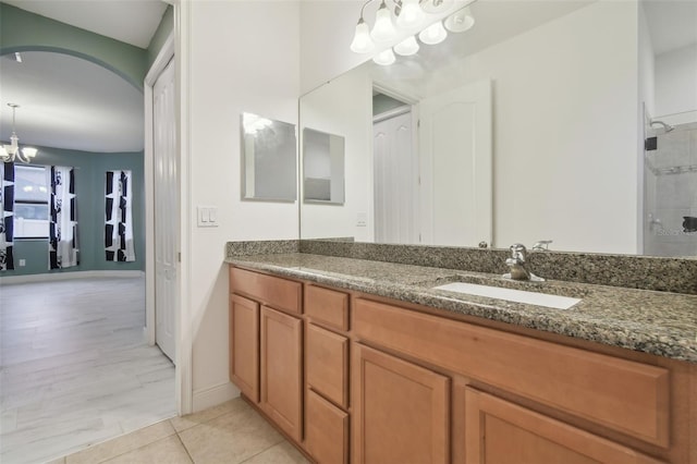 bathroom featuring vanity, tile patterned floors, a chandelier, and walk in shower