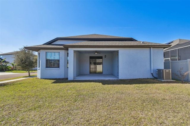 back of property featuring a patio, a yard, cooling unit, and ceiling fan