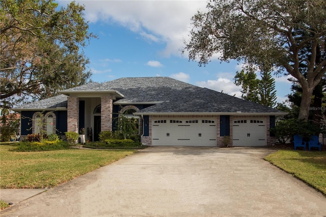 view of front of property with a garage and a front lawn