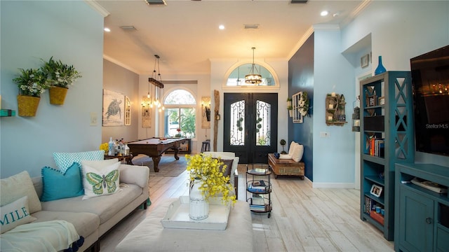 playroom featuring crown molding, french doors, and light wood-type flooring