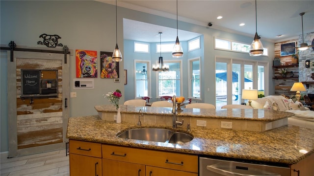 kitchen featuring sink, decorative light fixtures, stainless steel dishwasher, ornamental molding, and light stone countertops