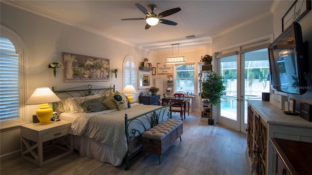 bedroom with hardwood / wood-style floors, ornamental molding, and access to outside