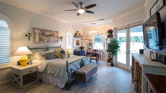 bedroom featuring access to exterior, ornamental molding, and hardwood / wood-style floors