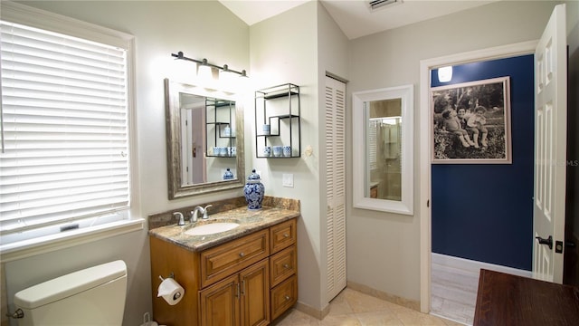 bathroom with tile patterned floors, vanity, and toilet