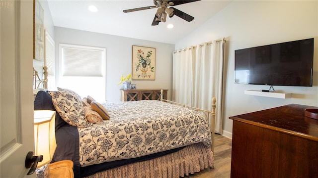 bedroom featuring vaulted ceiling, ceiling fan, and light wood-type flooring