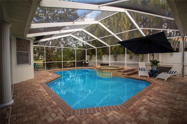 view of swimming pool with a lanai, a patio area, and an in ground hot tub