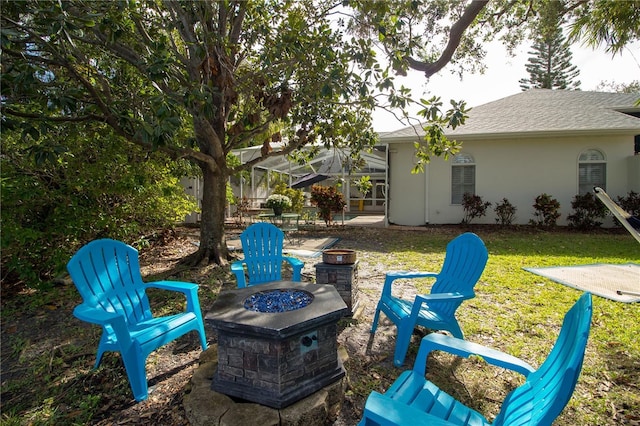 view of patio / terrace featuring a lanai and an outdoor fire pit