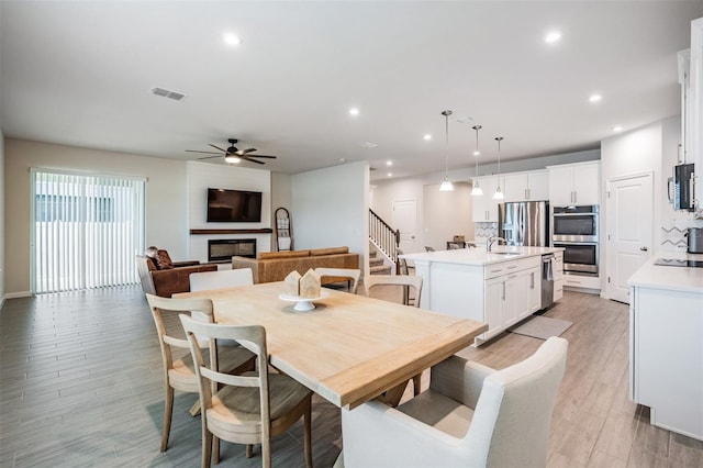 dining area with sink and ceiling fan