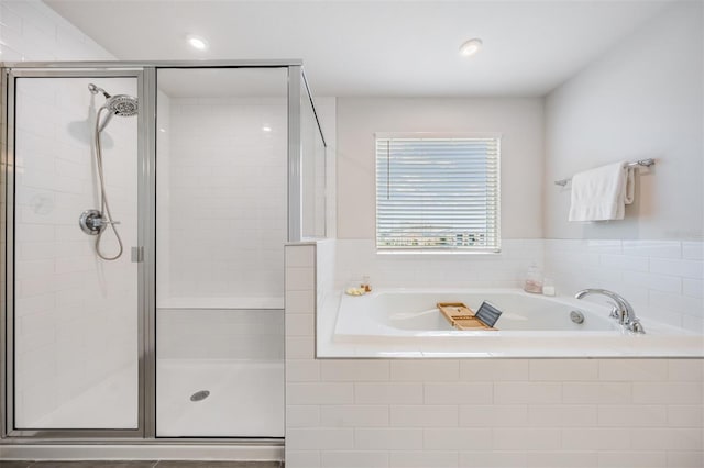 bathroom featuring separate shower and tub