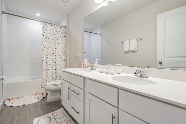 full bathroom featuring shower / tub combo, vanity, and toilet