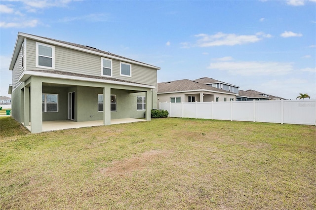 back of property featuring a patio area and a lawn