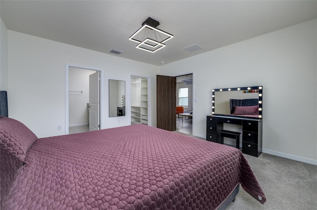 bedroom featuring a closet, a walk in closet, and carpet flooring