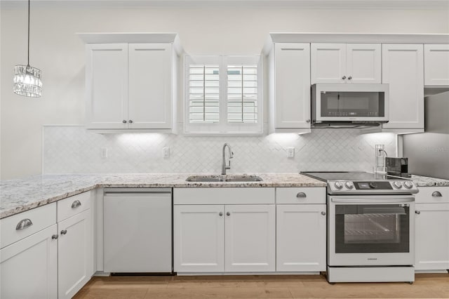 kitchen with tasteful backsplash, dishwashing machine, sink, stainless steel range with electric stovetop, and white cabinets