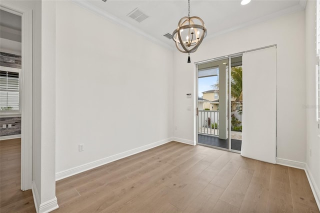 interior space featuring ornamental molding, light hardwood / wood-style flooring, and a notable chandelier