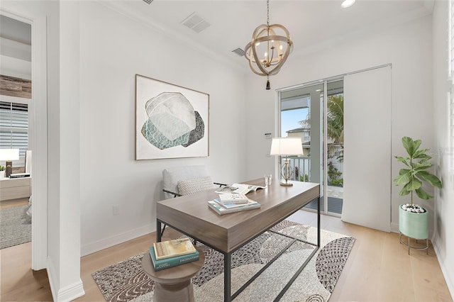 home office with light hardwood / wood-style flooring, ornamental molding, and a chandelier