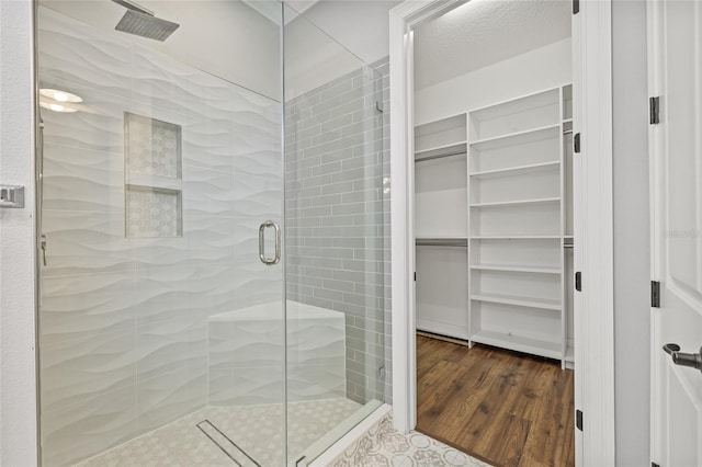 bathroom featuring hardwood / wood-style flooring and a shower with door