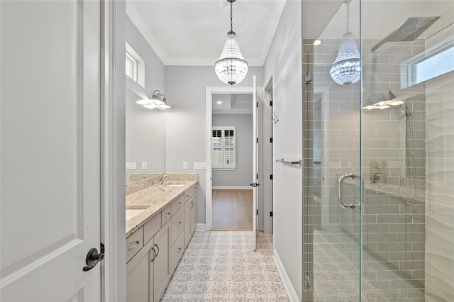 bathroom with tile patterned floors, a shower with door, vanity, a notable chandelier, and crown molding