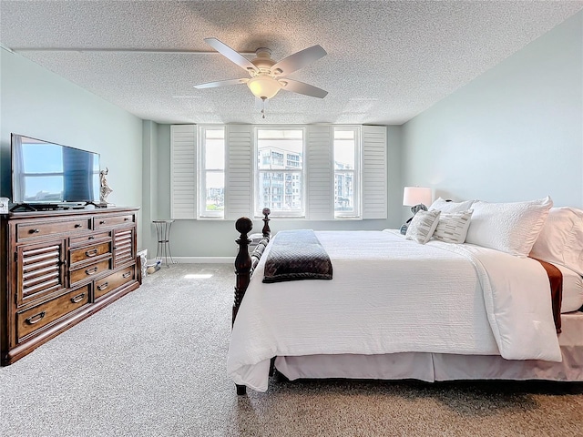 bedroom with a textured ceiling, ceiling fan, and carpet floors