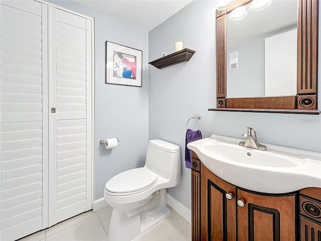 bathroom featuring tile patterned floors, vanity, and toilet