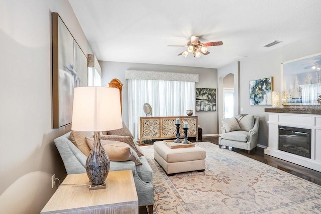 living room featuring hardwood / wood-style floors and ceiling fan