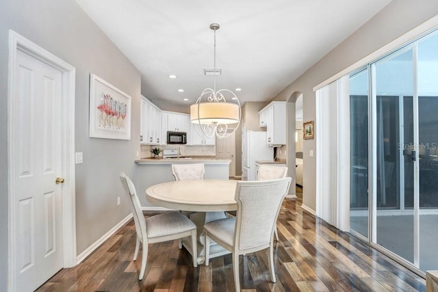 dining area with dark hardwood / wood-style floors