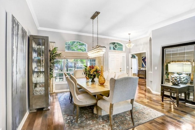 dining room with wood-type flooring, a chandelier, and crown molding