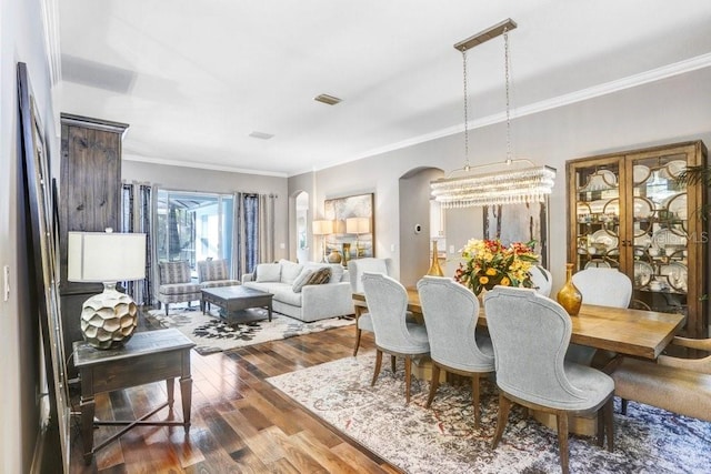 dining room featuring crown molding and hardwood / wood-style floors