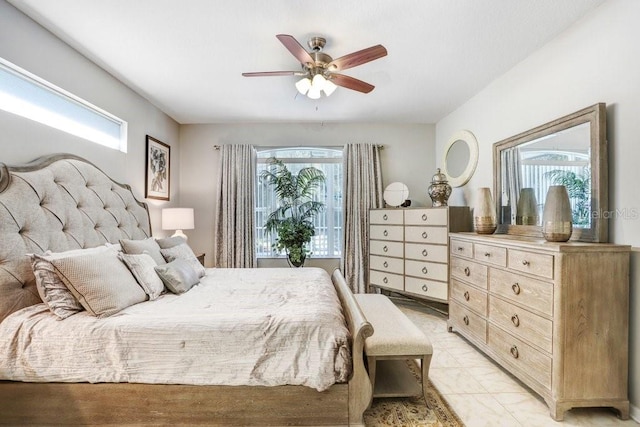 bedroom with multiple windows and ceiling fan