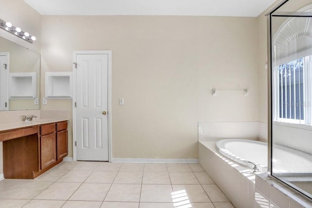 bathroom with a relaxing tiled tub, tile patterned floors, and vanity