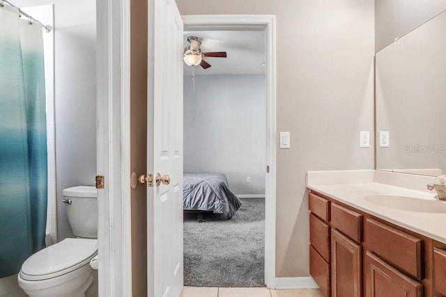 bathroom featuring vanity, ceiling fan, tile patterned flooring, and toilet