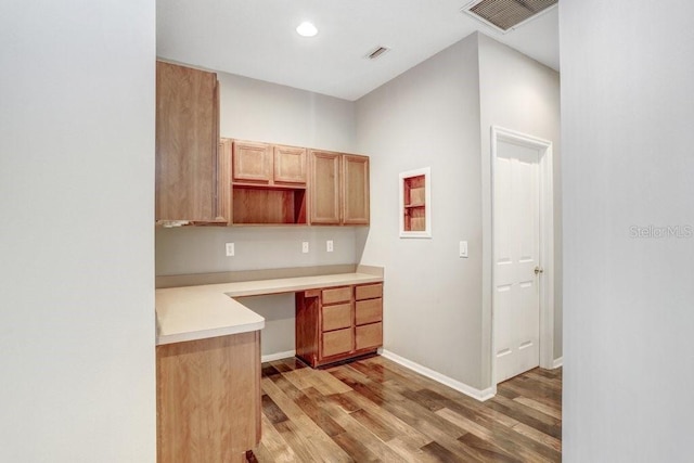 kitchen with light hardwood / wood-style flooring and built in desk