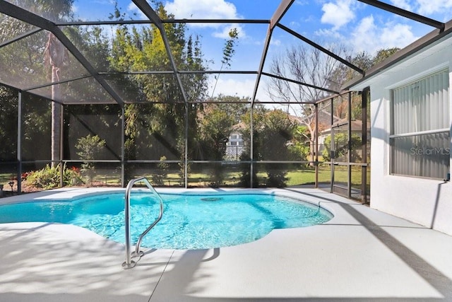 view of swimming pool featuring a patio area and glass enclosure