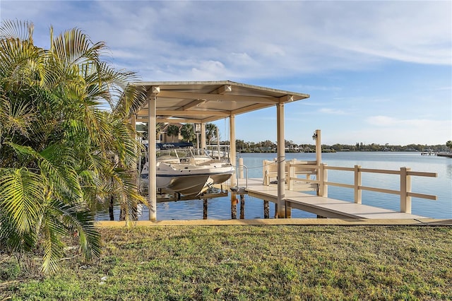 dock area with a water view and a lawn