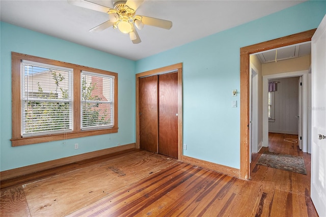 unfurnished bedroom with ceiling fan, hardwood / wood-style floors, and a closet