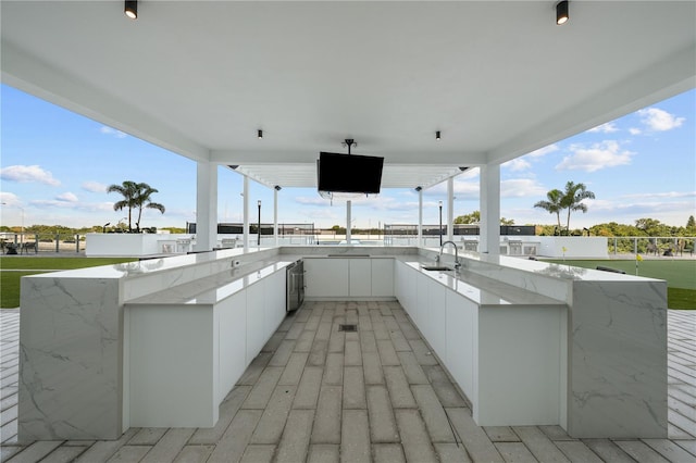 view of patio / terrace featuring a sink and exterior kitchen